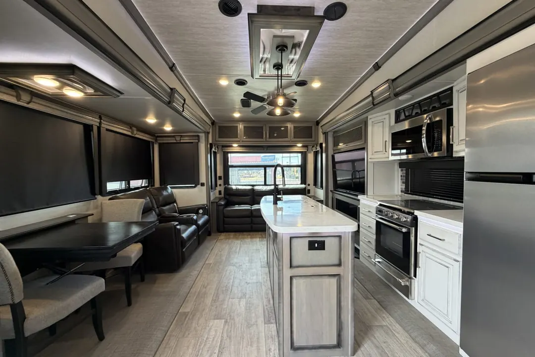 A wide interior view of a 2021 Keystone Montana fifth wheel with its kitchen island