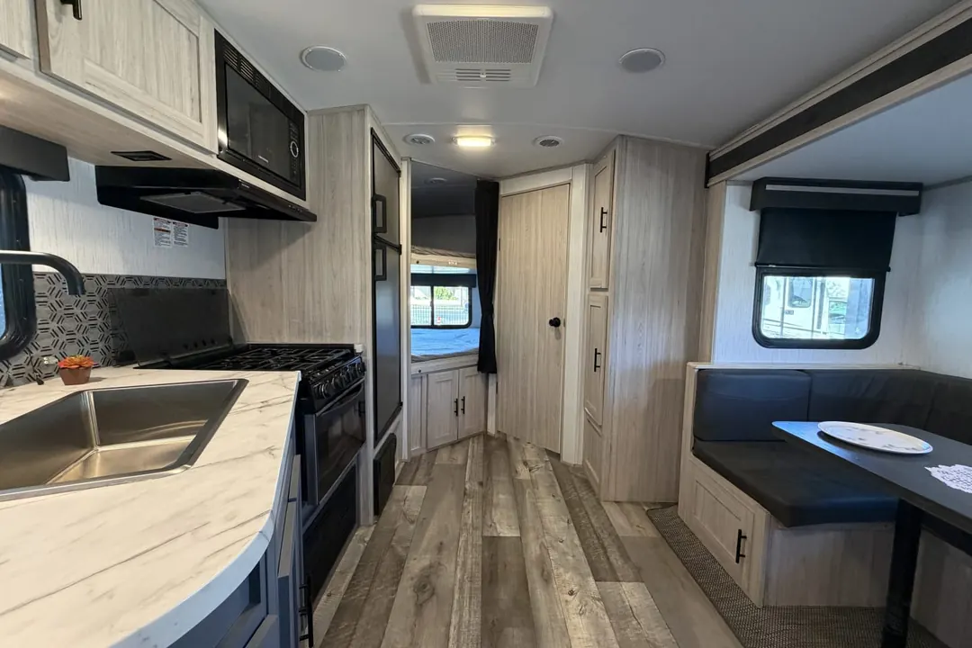 The kitchen and living area of a 2022 Heartland Sundance Ultra Lite