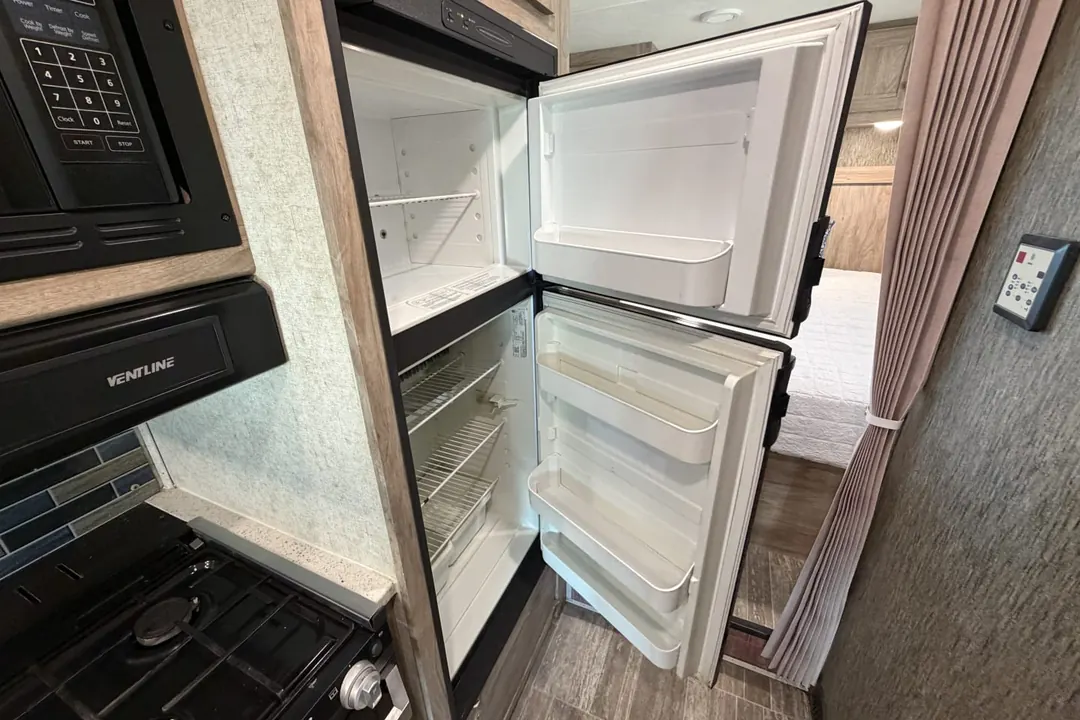 An open refrigerator in a 2019 Forest River Sunseeker