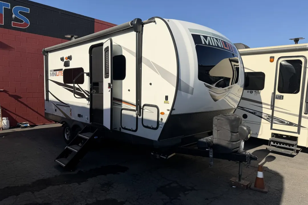 A 2021 Forest River Rockwood Mini Lite travel trailer on a lot