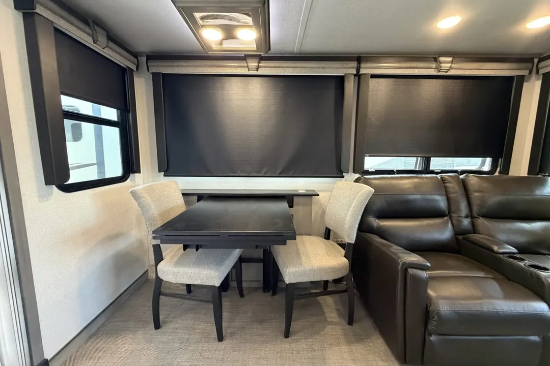 The living area of a 2021 Keystone Montana with recliners and a dinette