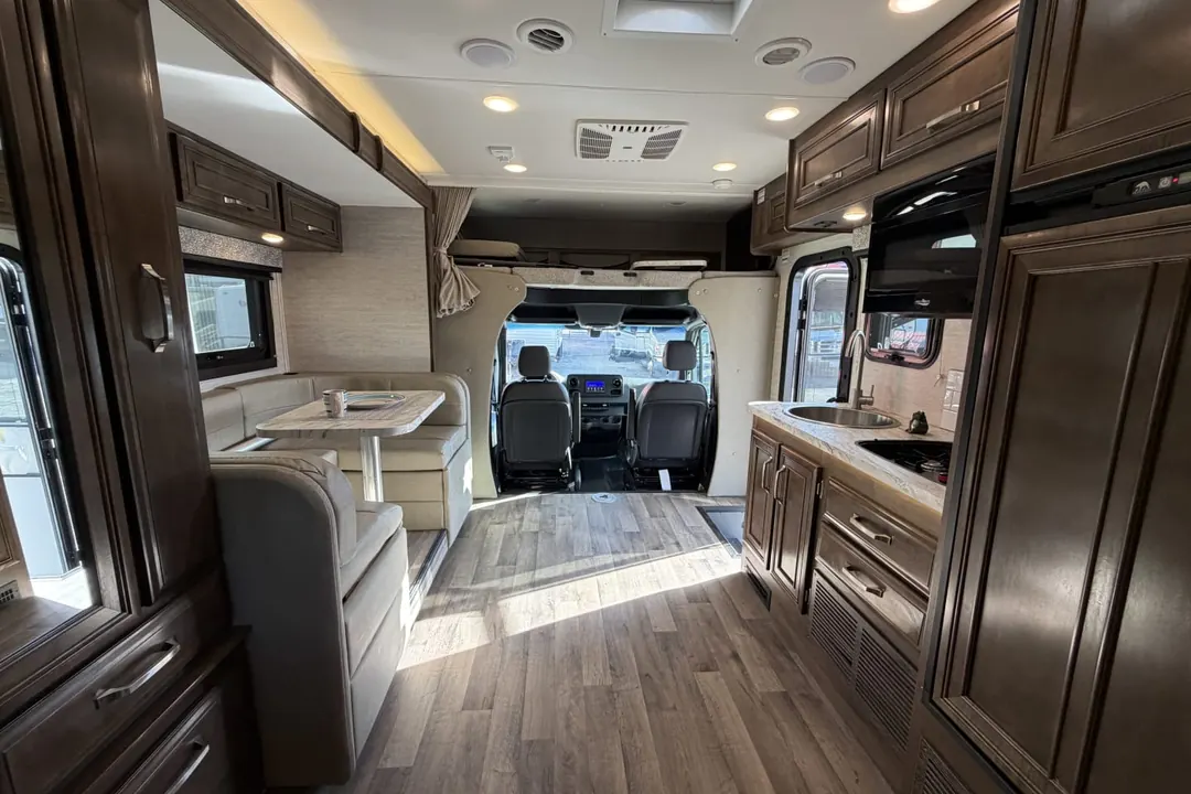 The full length interior of a 2021 Jayco Melbourne, from the bedroom to the cab