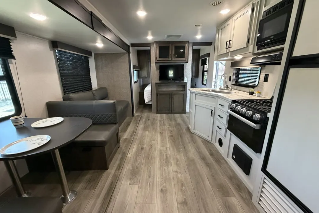 The interior of a 2021 Highland Ridge Open Range from the dinette to the kitchen