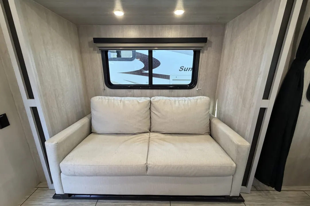 The sofa in the lounge of a 2023 Genesis Supreme Sea Breeze
