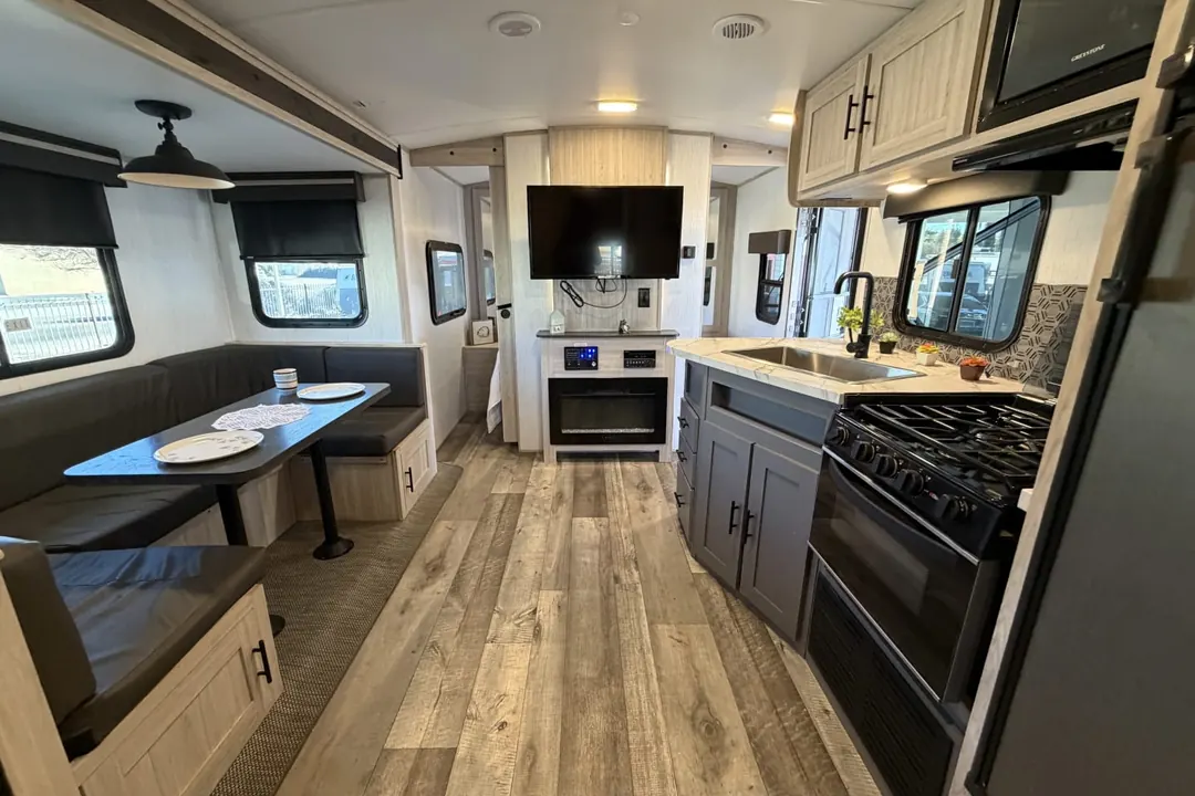 The dinette, kitchen and living area of a 2022 Heartland Sundance Ultra Lite