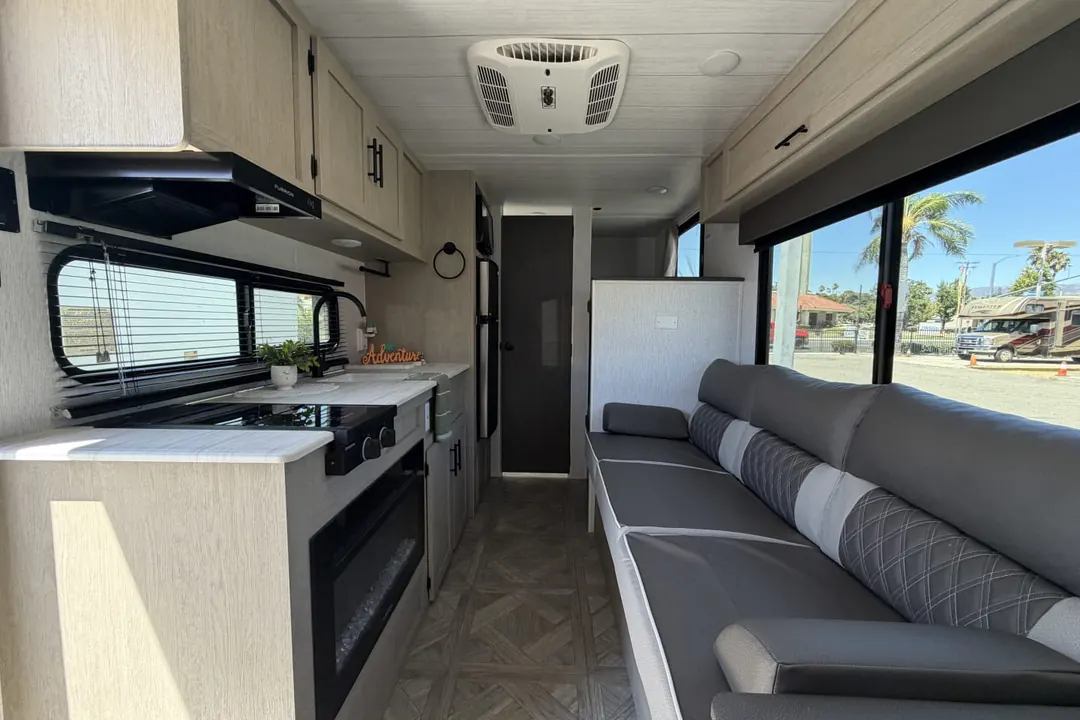 The kitchen and sofa inside a 2024 Forest River Evo