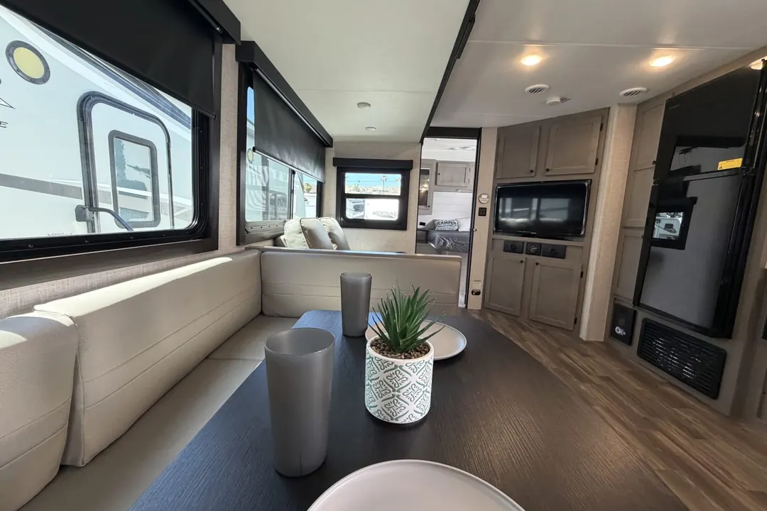 The dinette and living area of a 2024 Starcraft Super Lite