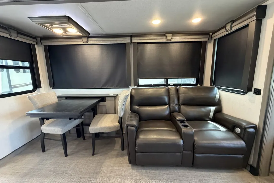 The living area of a 2021 Keystone Montana fifth wheel with recliners and a dinette
