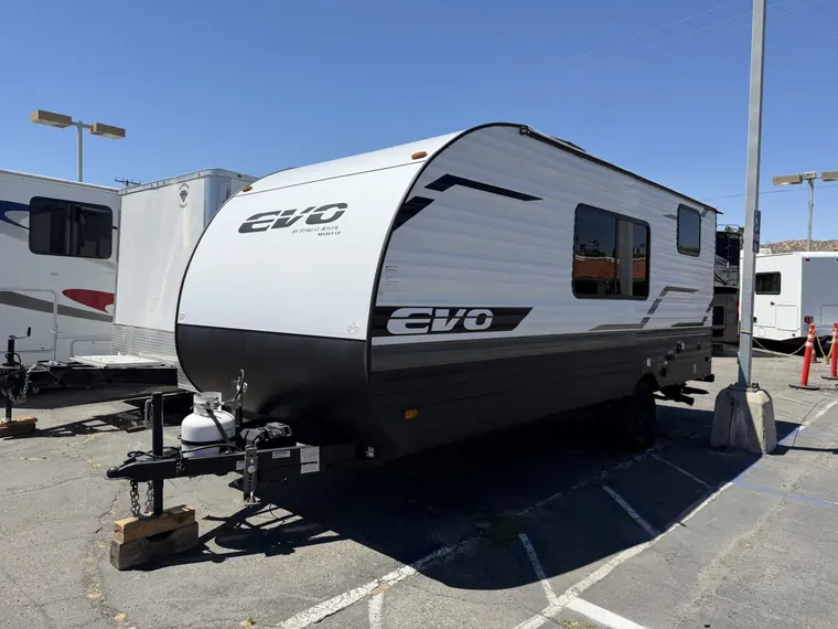 2024 Forest River Evo travel trailer parked on an open paved lot